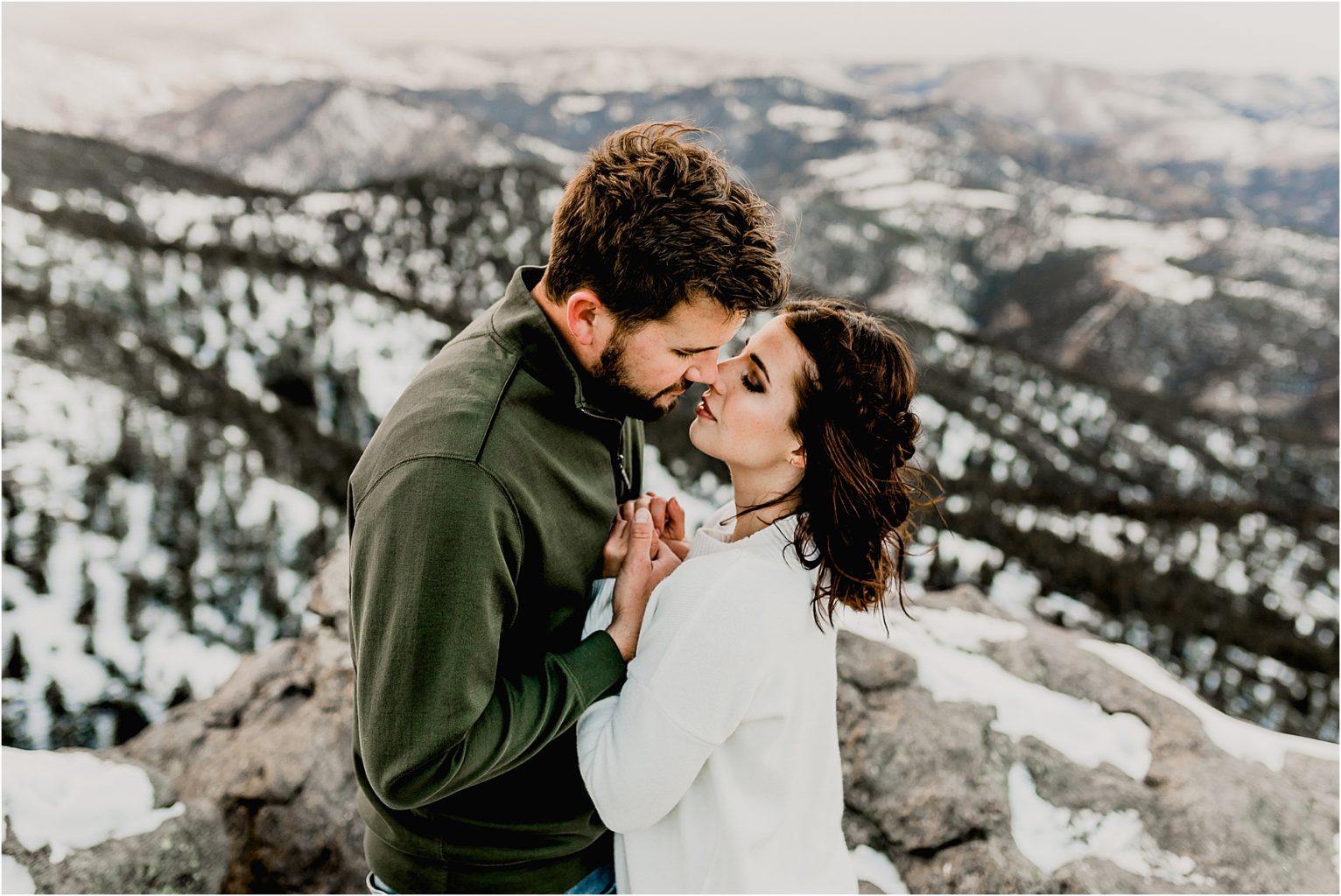 beautiful colorado engagement session in the snow covered trees and mountains of lost gulch lookout