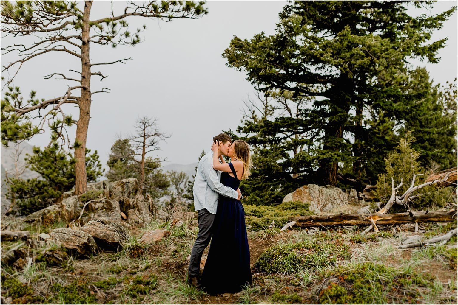 engaged couple hugging in the mountains of boulder Colorado