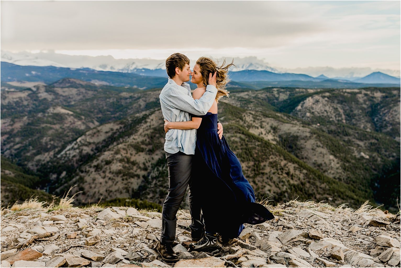 engaged couple in boulder Colorado mountains with beautiful mountain backdrop