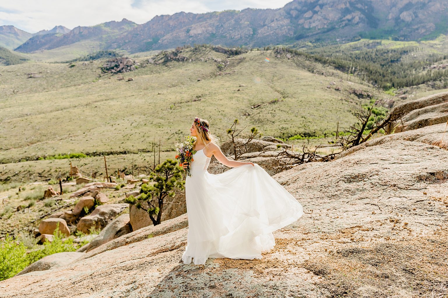 beautiful bride in wedding dress for Colorado elopement with mountain background