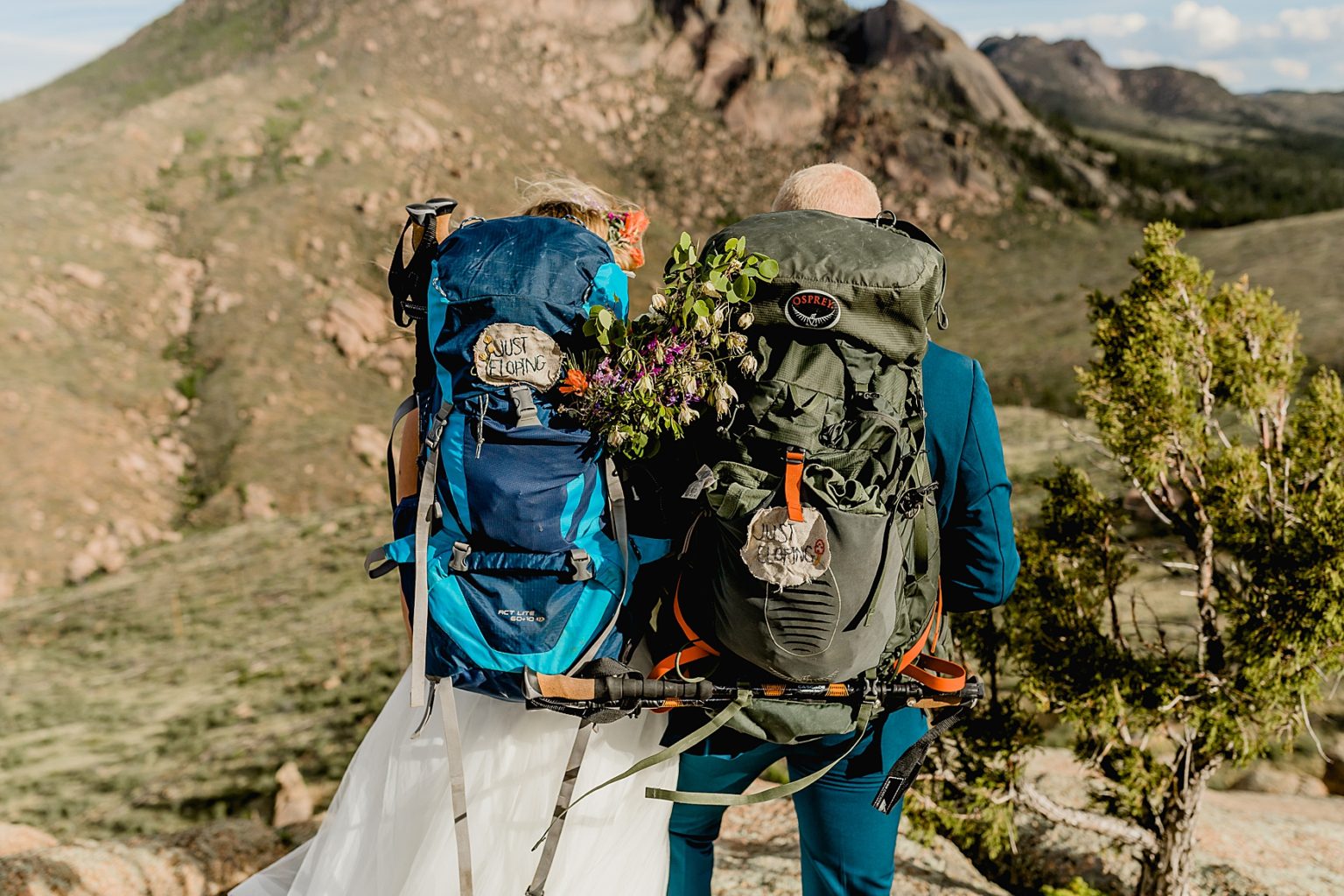 bride and groom hiking with backpacks for their Colorado elopement in the mountains