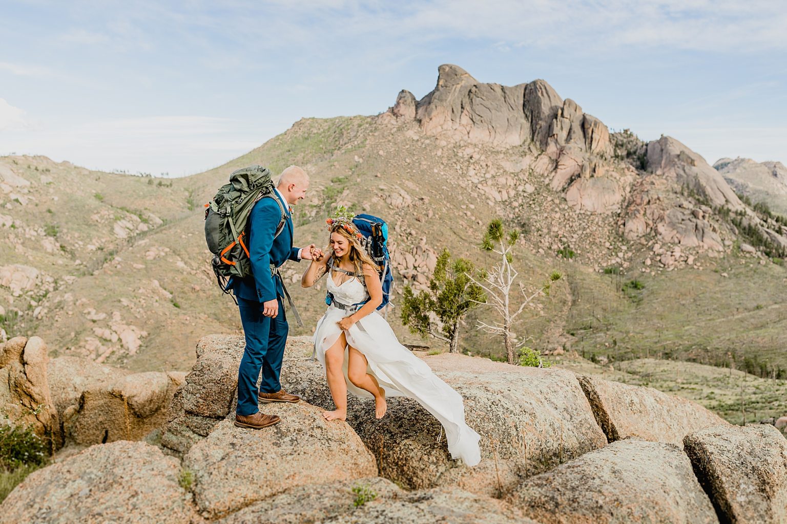 bride and groom hiking with backpacks for their Colorado elopement in the mountains