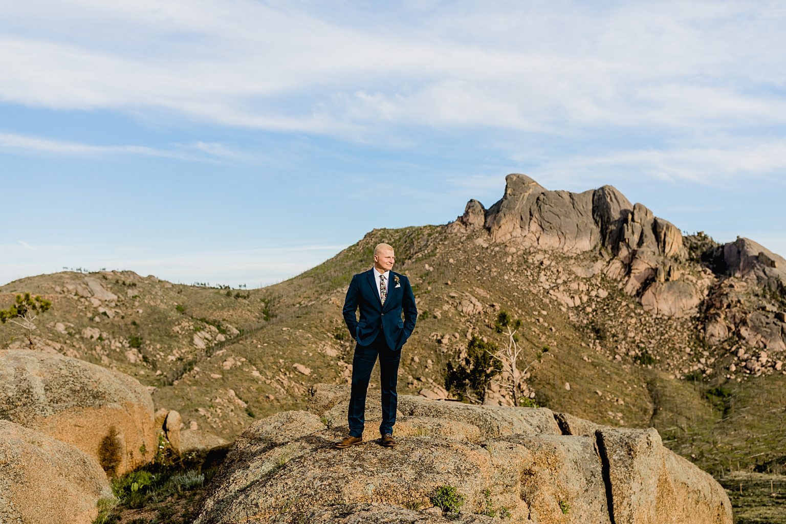 groom standing on rock for Colorado elopement