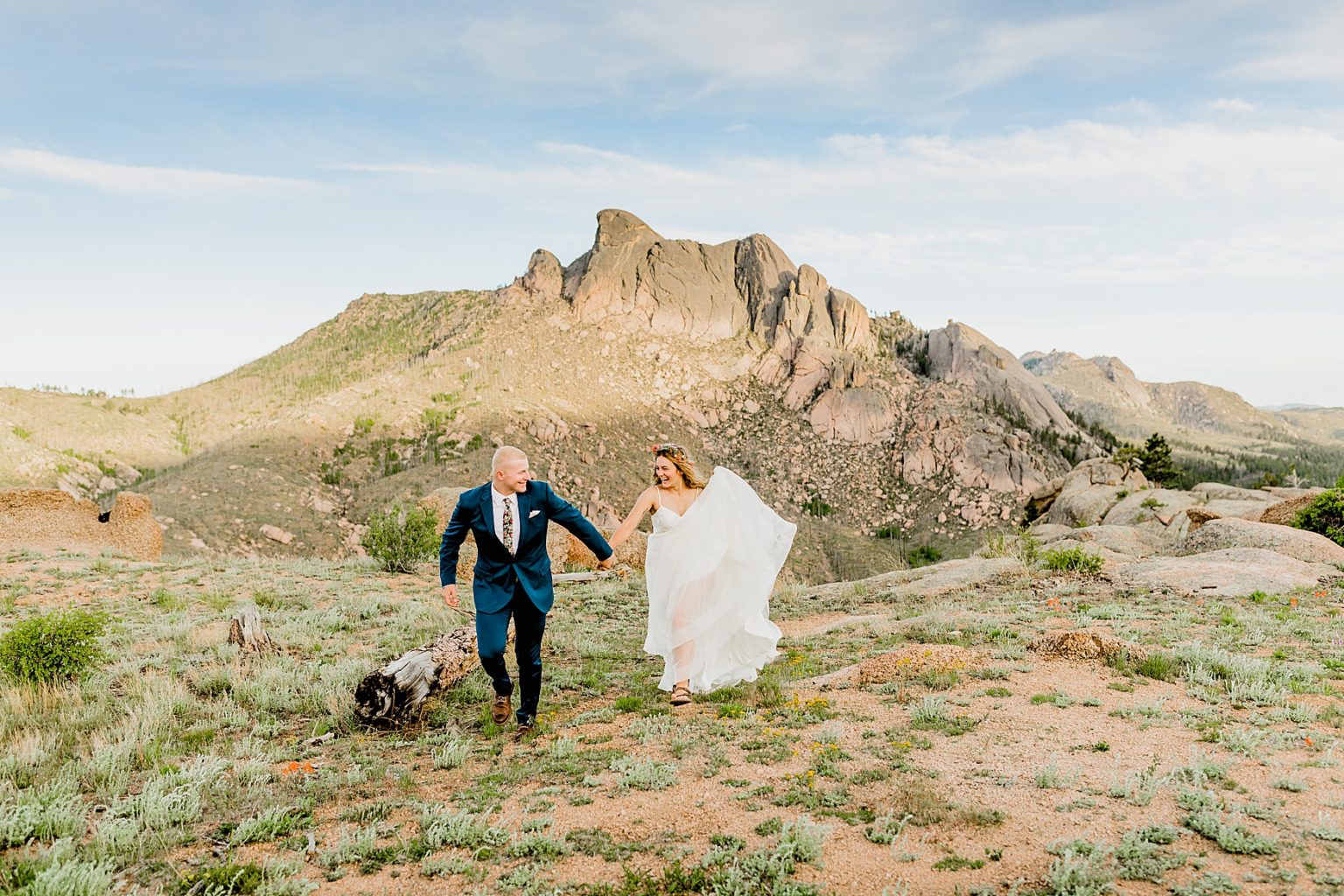 adventure elopement with bride and groom running and having fun in the Rocky Mountains