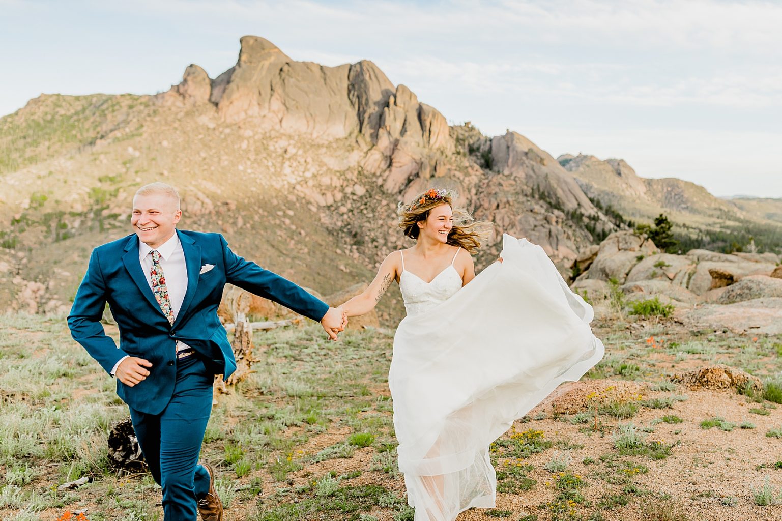 adventure elopement with bride and groom running and having fun in the Rocky Mountains