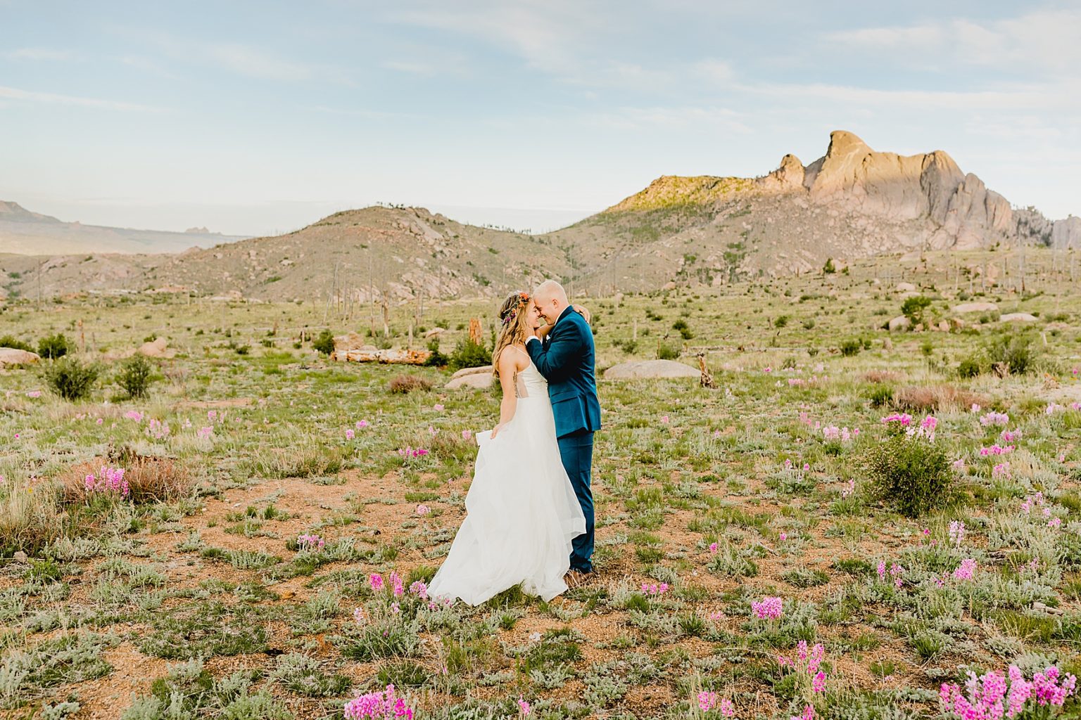 bride and groom in Colorado in the mountains surrounded by wildflowers for mountain elopement