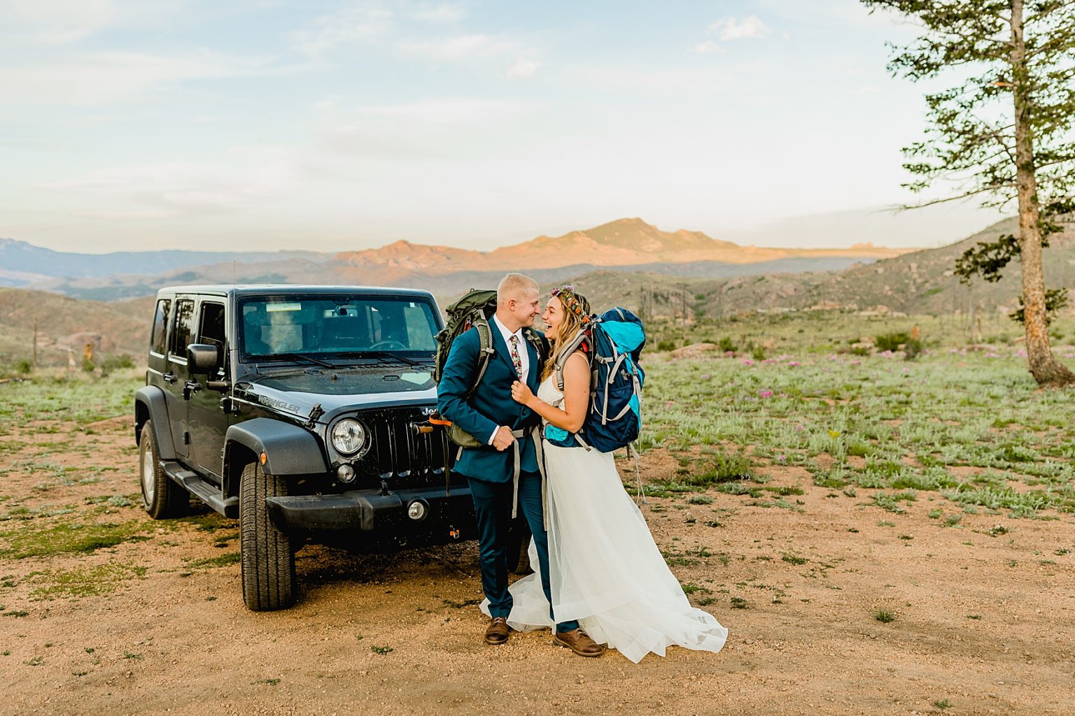 bride and groom standing by jeep for adventure elopement