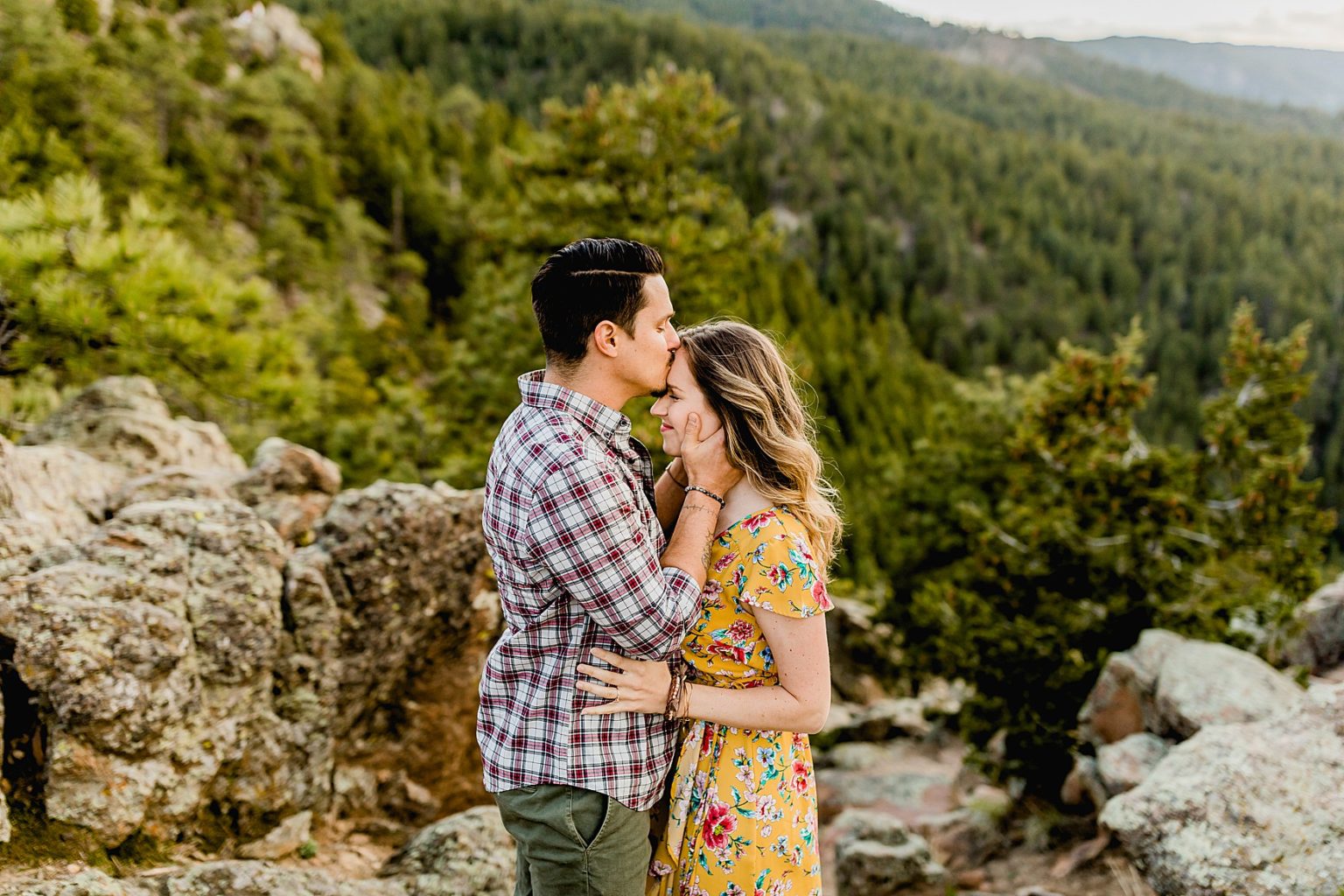 couple embracing together in boulder colorado for engagement photos in the mountains