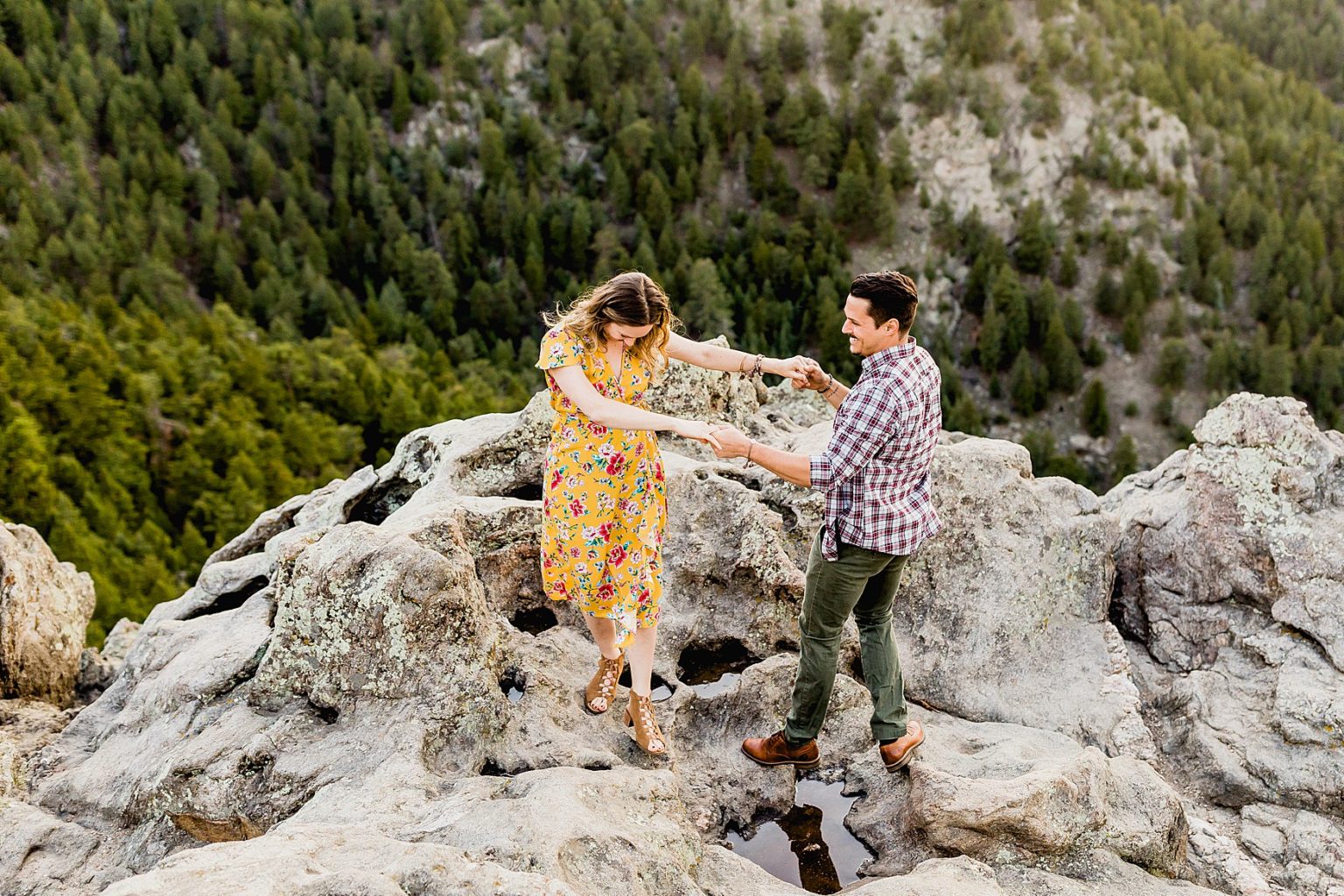 couple walking on rocks lost gulch lookout in colorado