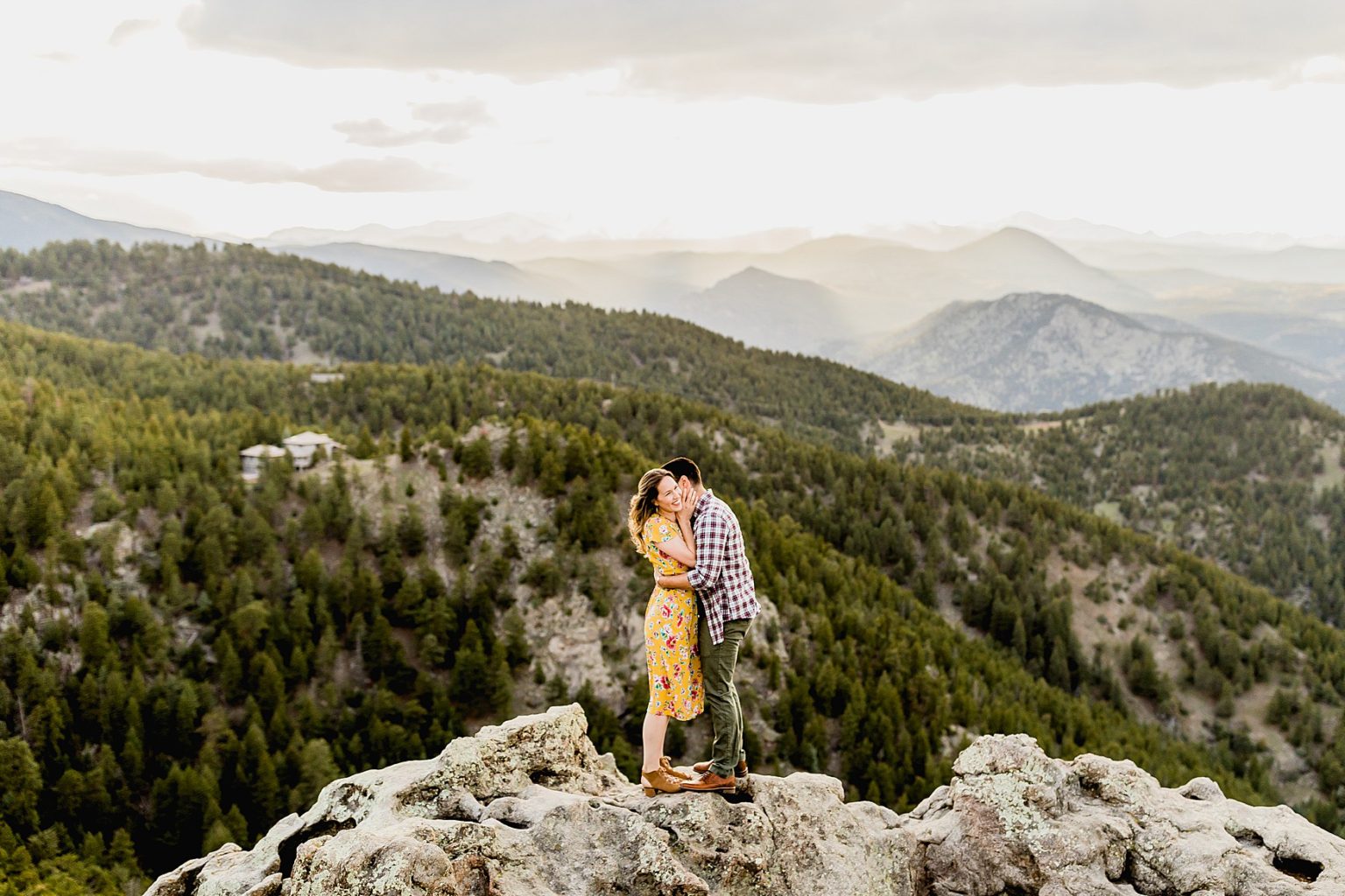 couple standing on rock at lost gulch lookout in boulder colorado with the beautiful Rocky Mountain scenic background