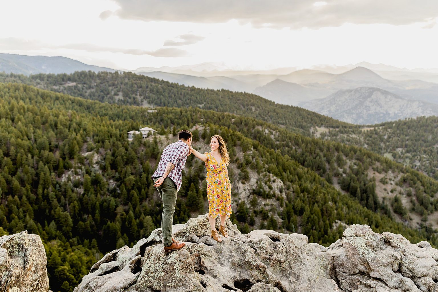 couple standing on rock at lost gulch lookout in boulder colorado with the beautiful Rocky Mountain scenic background