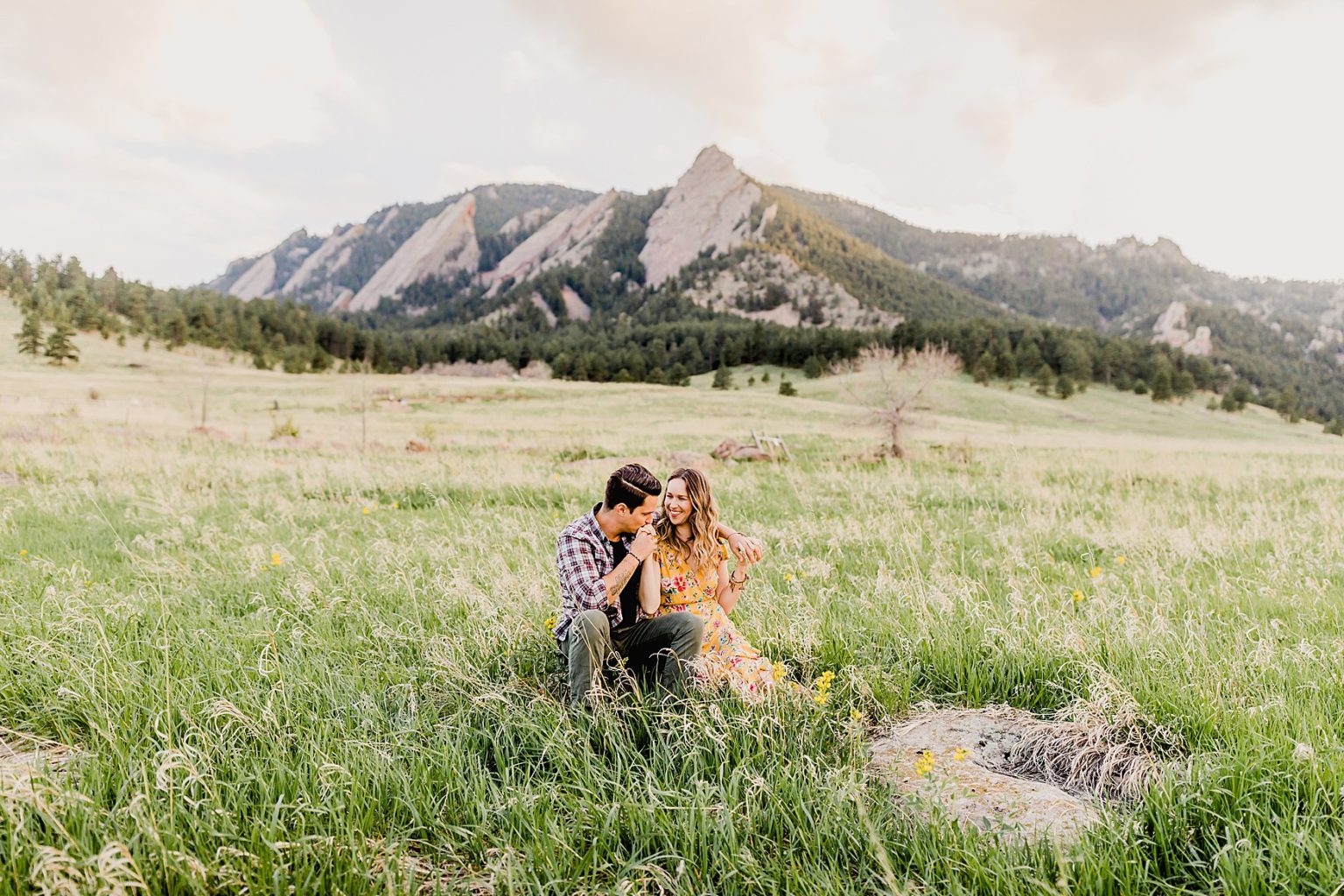 adorable couple having fun at chautauqua park in boulder colorado for their summer engagement photos
