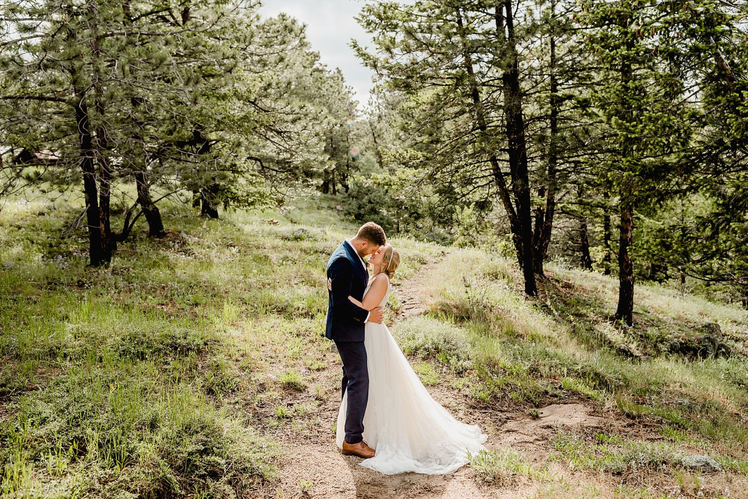 bride and groom are excited for their elopement in the forest and trees of boulder colorado