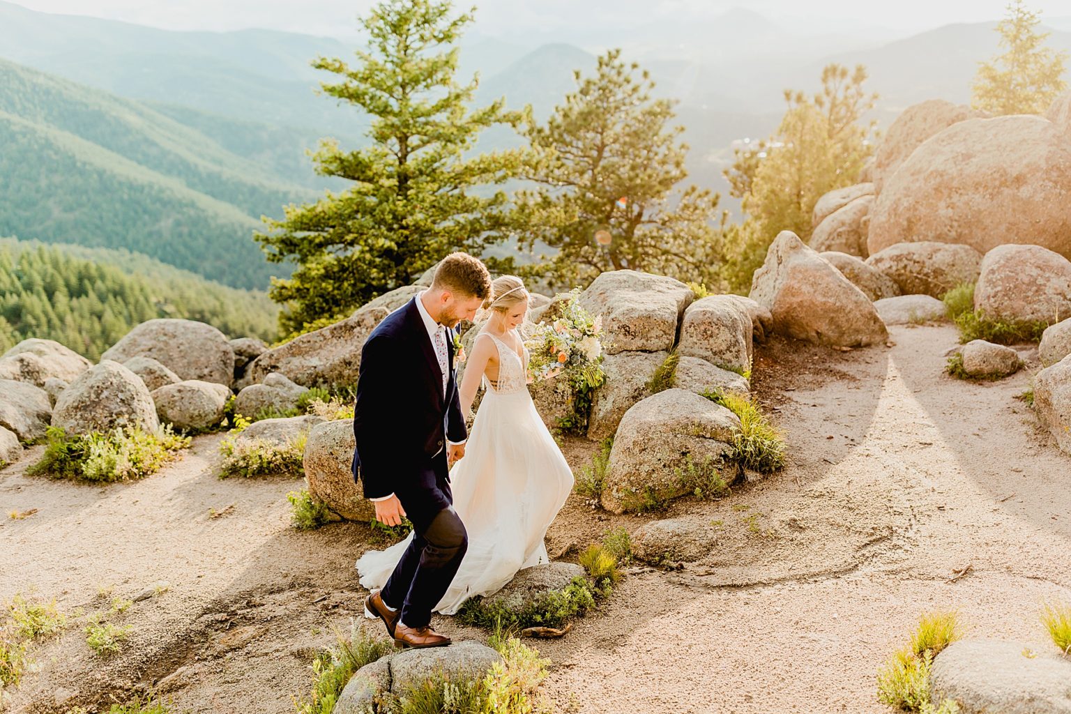 couple hiking for their Colorado elopement in the beautiful green Rocky Mountains of boulder