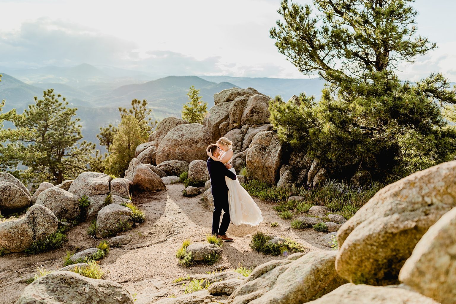 groom spins bride around with beautiful Rocky Mountain colorado background