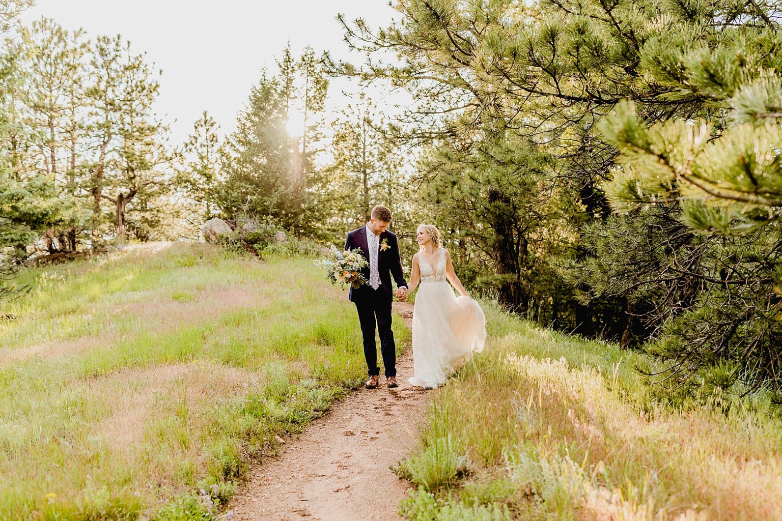 couple hiking for their Colorado elopement in the beautiful green Rocky Mountains of boulder