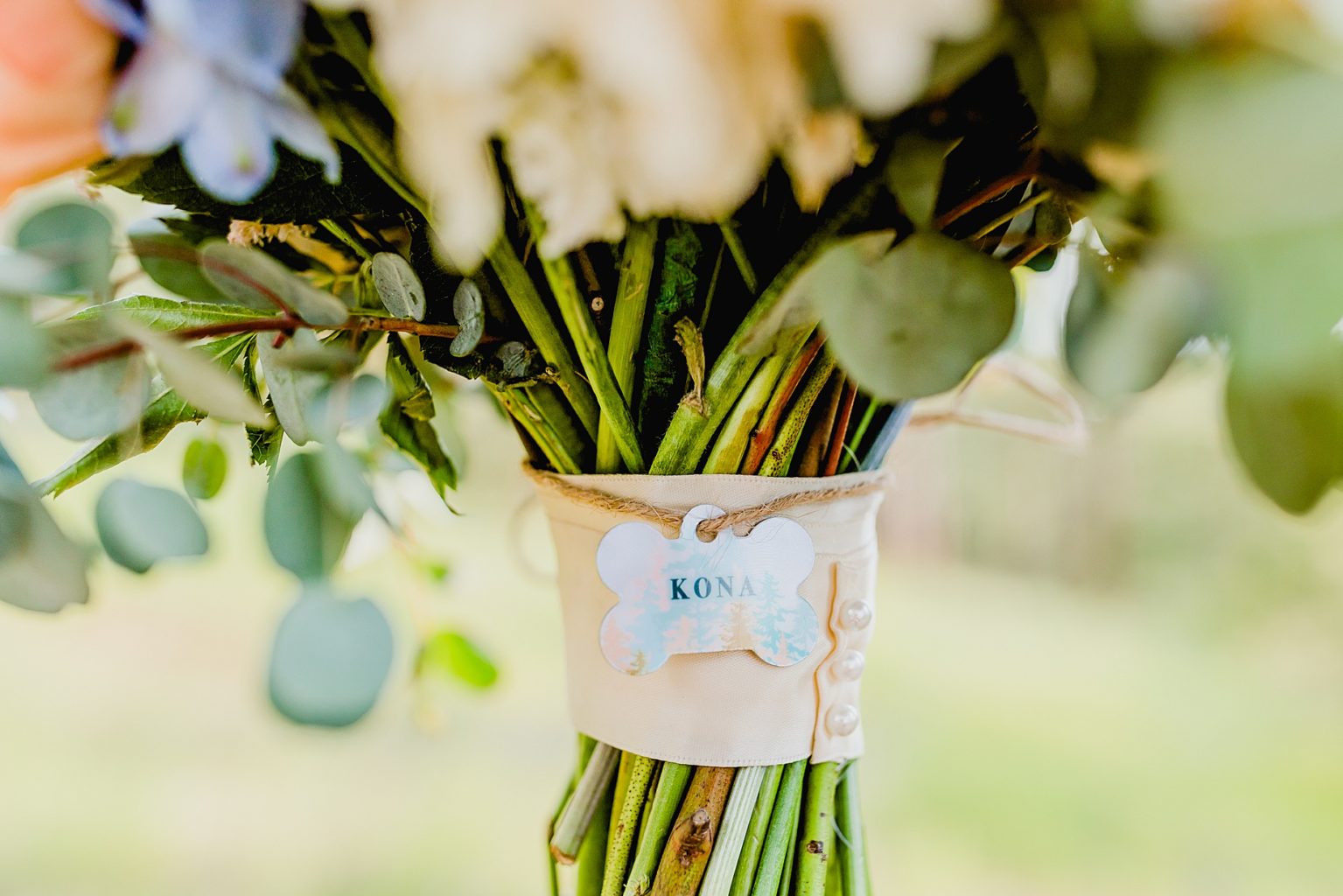 dog tag is attached to a wedding bouquet