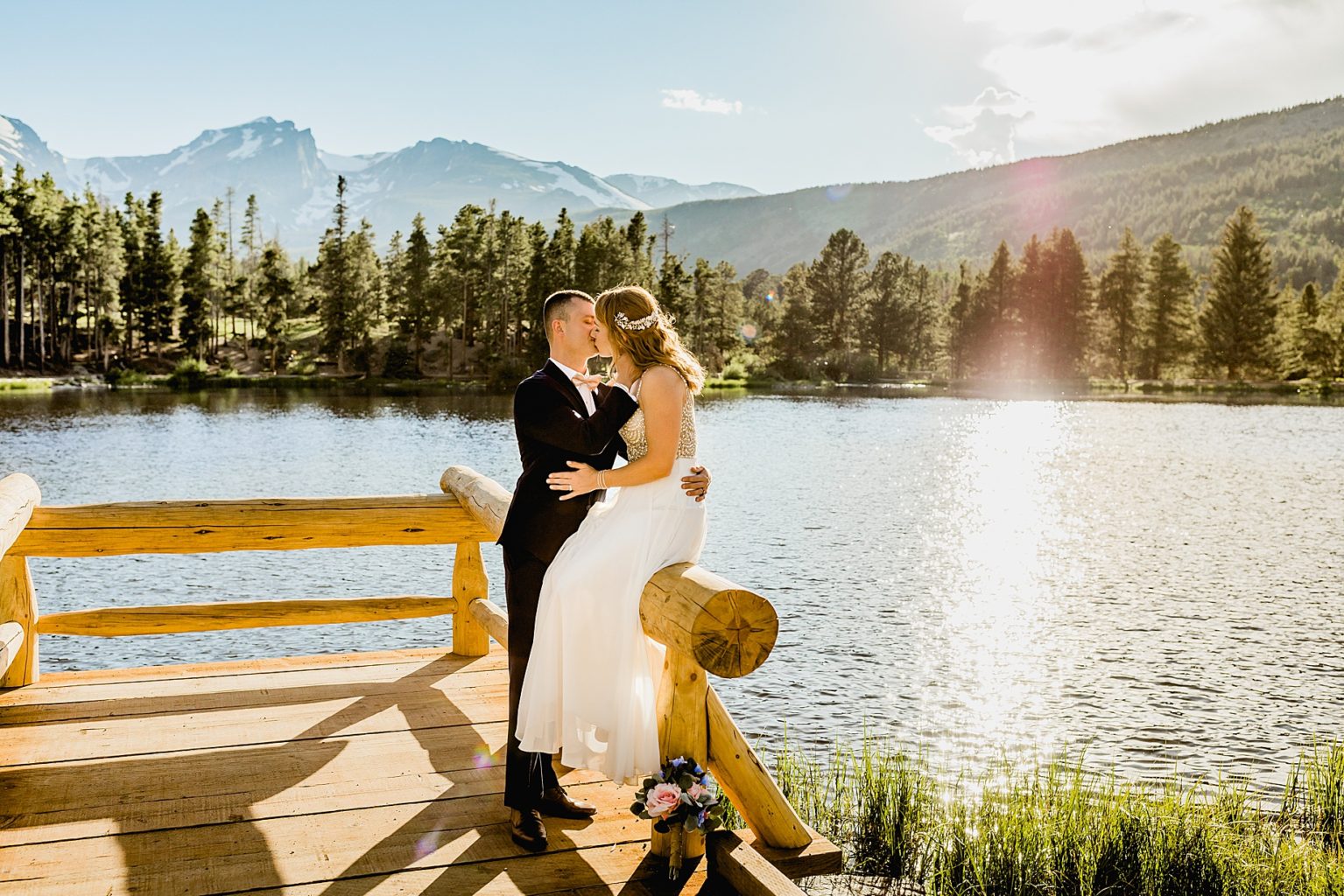 bride and groom embrace after elopement ceremony at in Rocky Mountain national park colorado