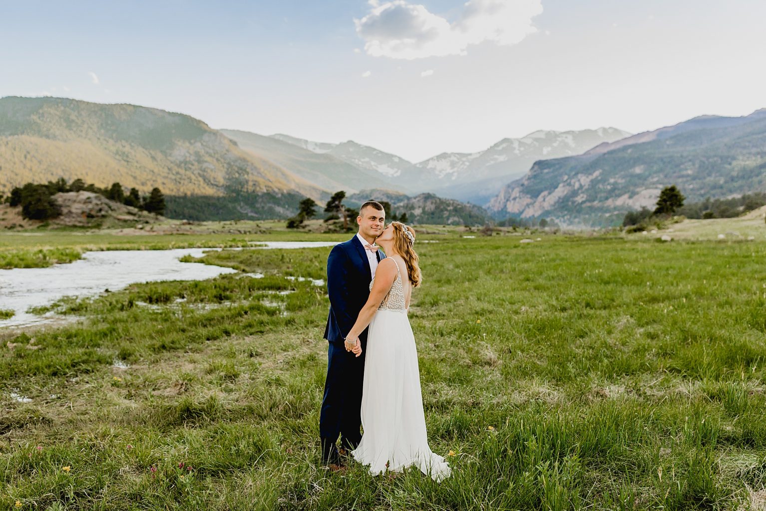 couple dances together after elopement in beautiful Rocky Mountain national park with gorgeous mountain backdrop