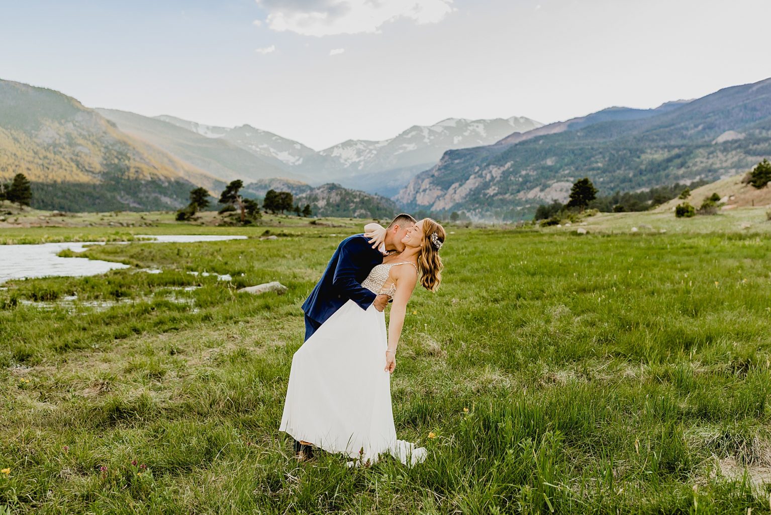 couple dances together after elopement in beautiful Rocky Mountain national park with gorgeous mountain backdrop
