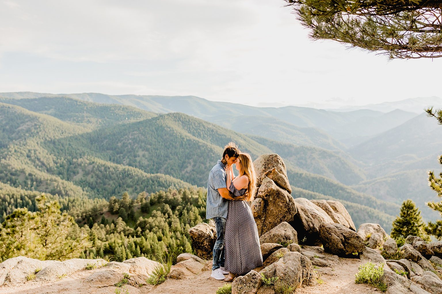 couples hugs each other with colorado mountain scenery