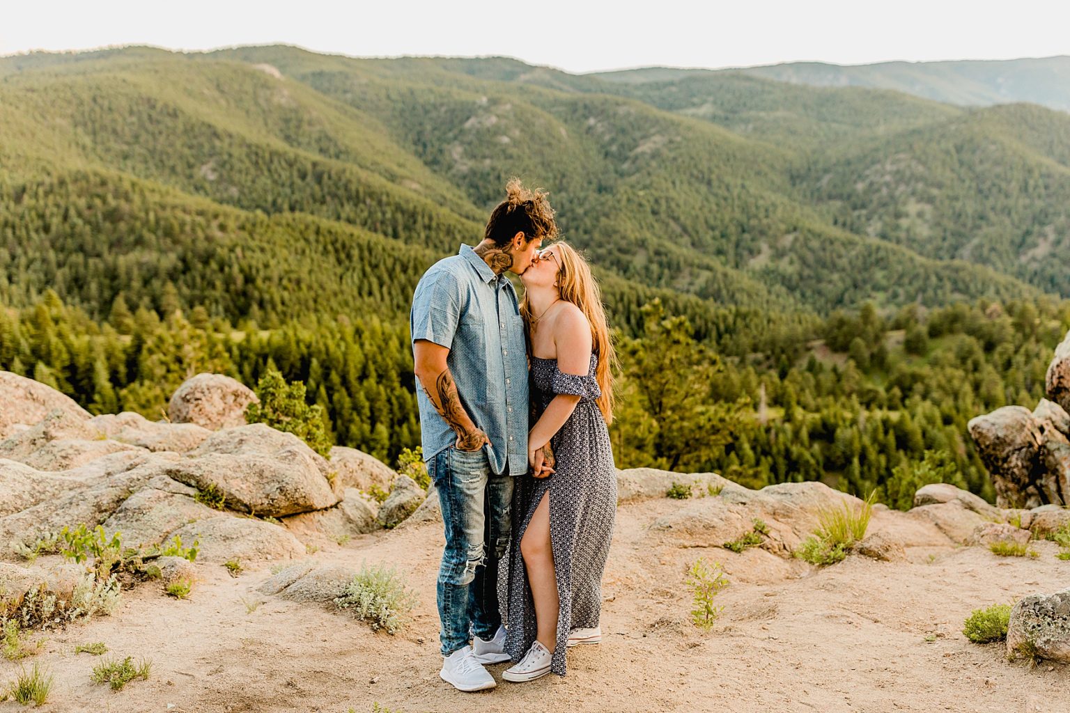 couple stands together in boulder colorado with incredible mountain scenery