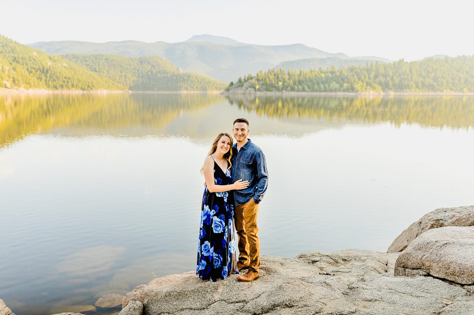 evergreen trees and lake background with couple celebrating anniversary in boulder colorado