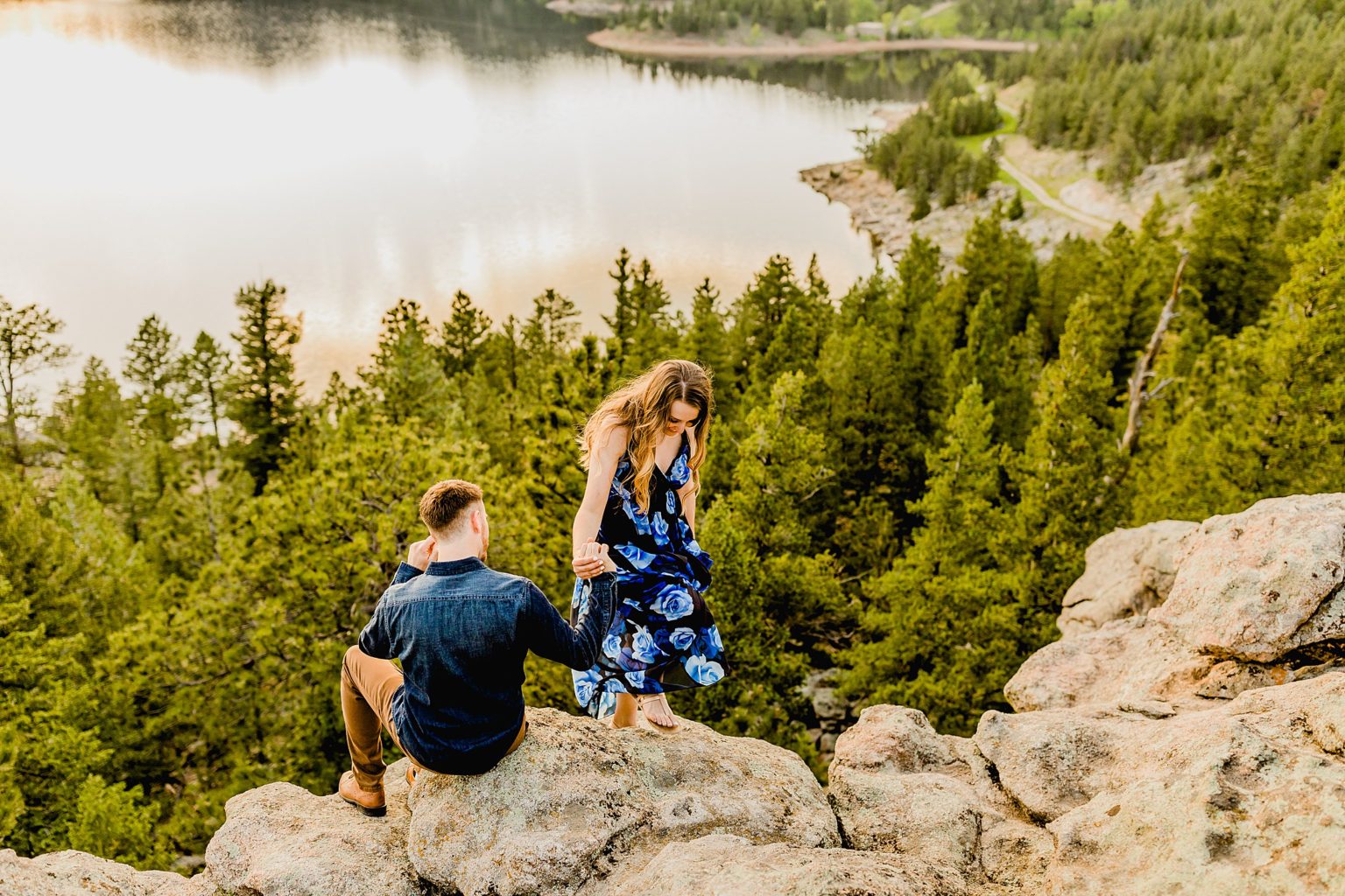 couple stands together in boulder colorado with stunning greenery and mountain scenery around them