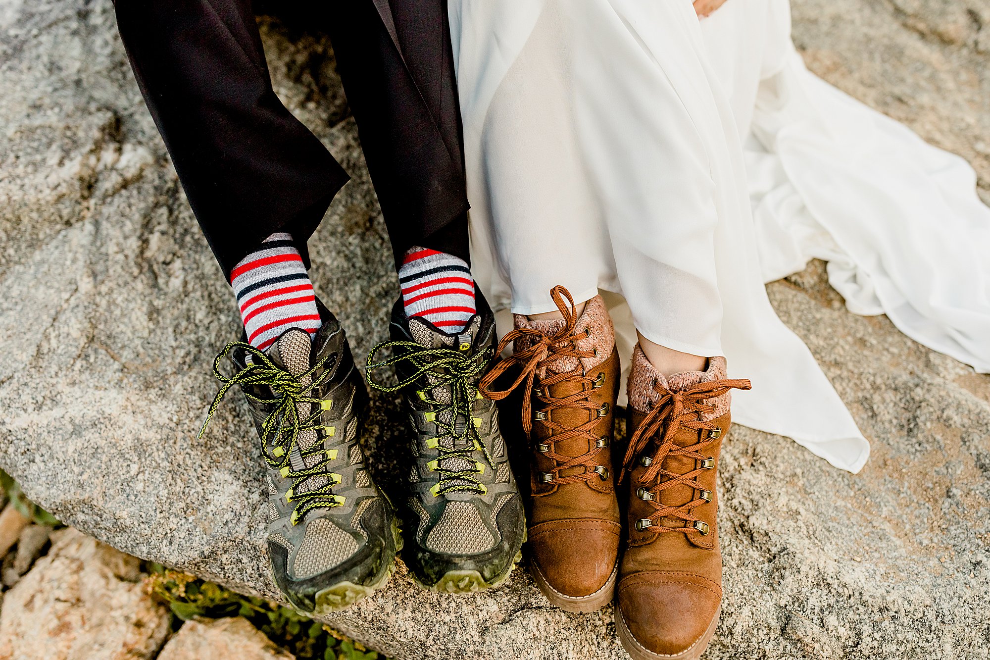 bride and groom show off hiking boots for their colorado adventure hiking elopement
