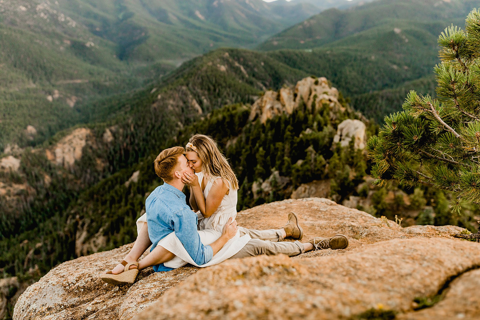 colorado couple cuddles up together with gorgeous mountain scenery
