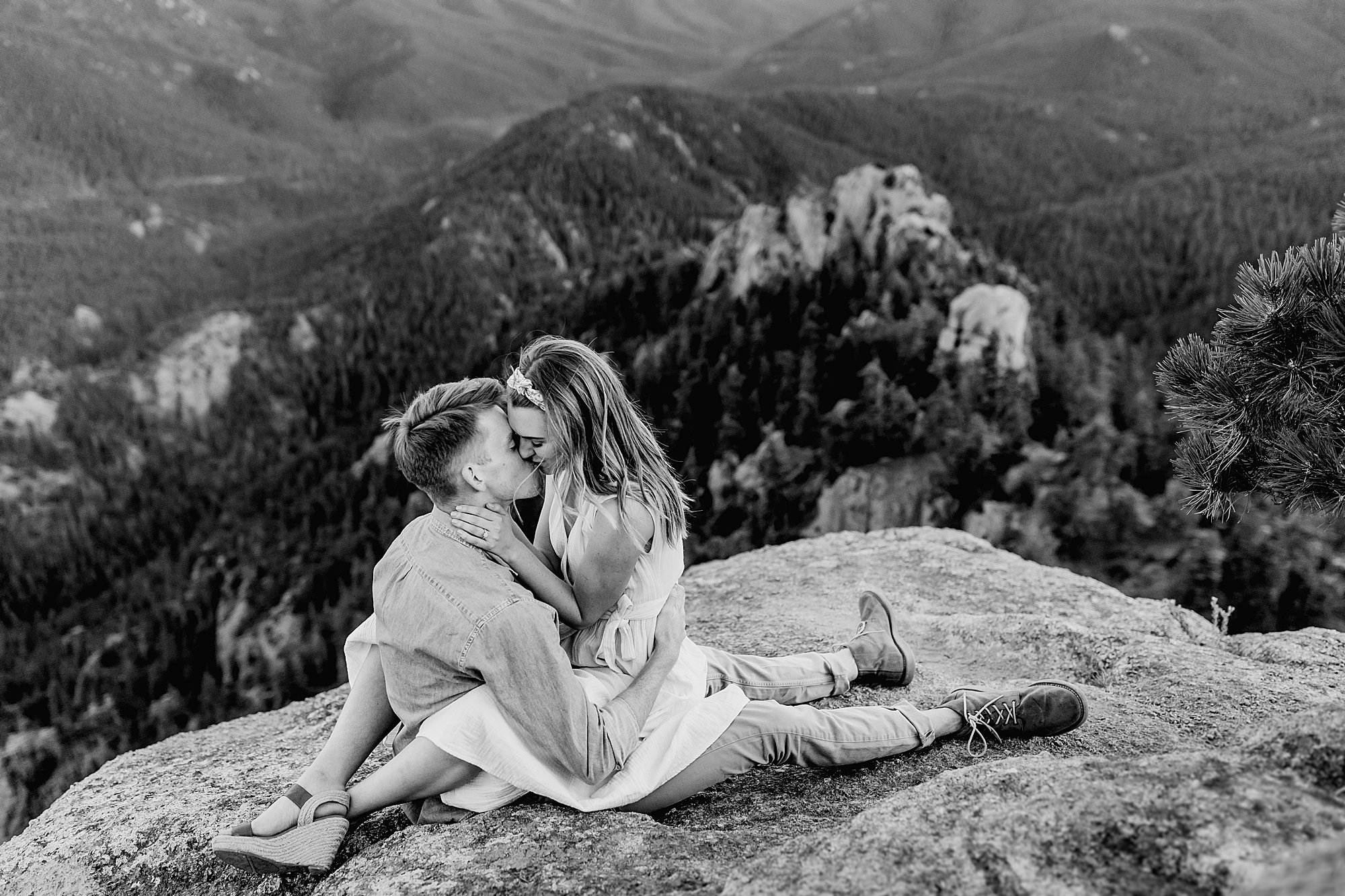colorado couple cuddles up together with gorgeous mountain scenery