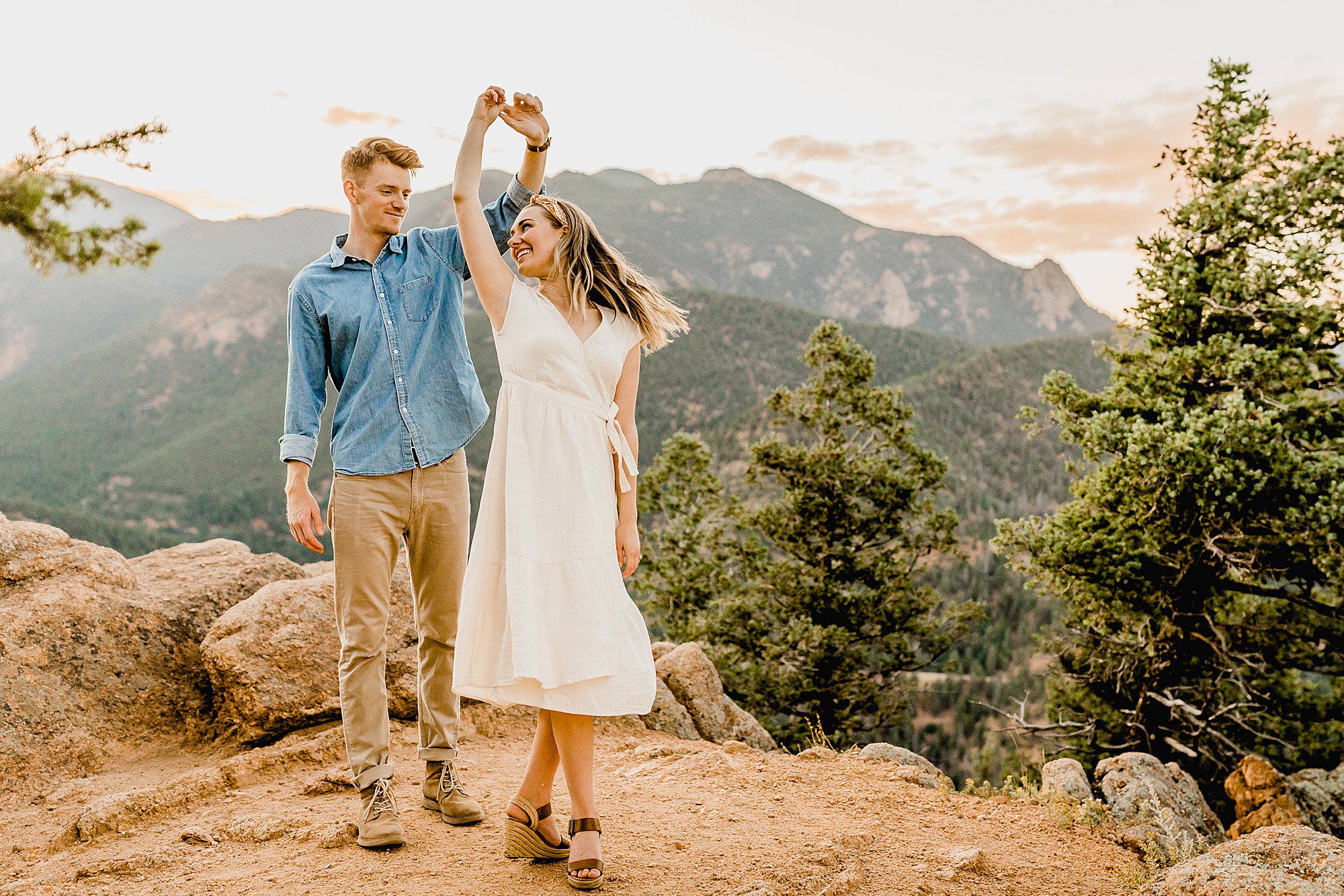 couple dances together for colorado engagement photos in cheyenne mountain