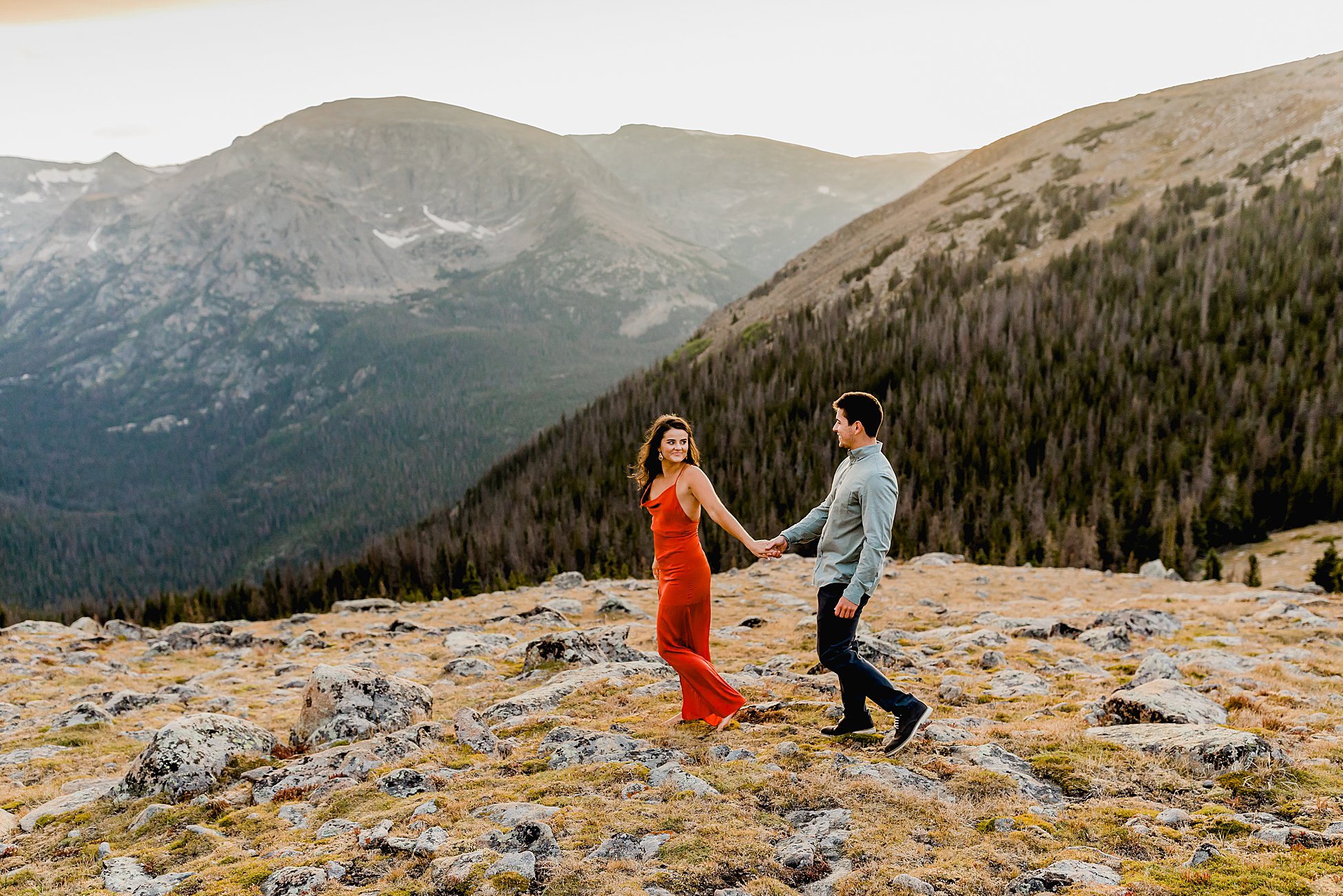 photographer captures rocky mountain national park proposal with gorgeous mountain scenery at sunset