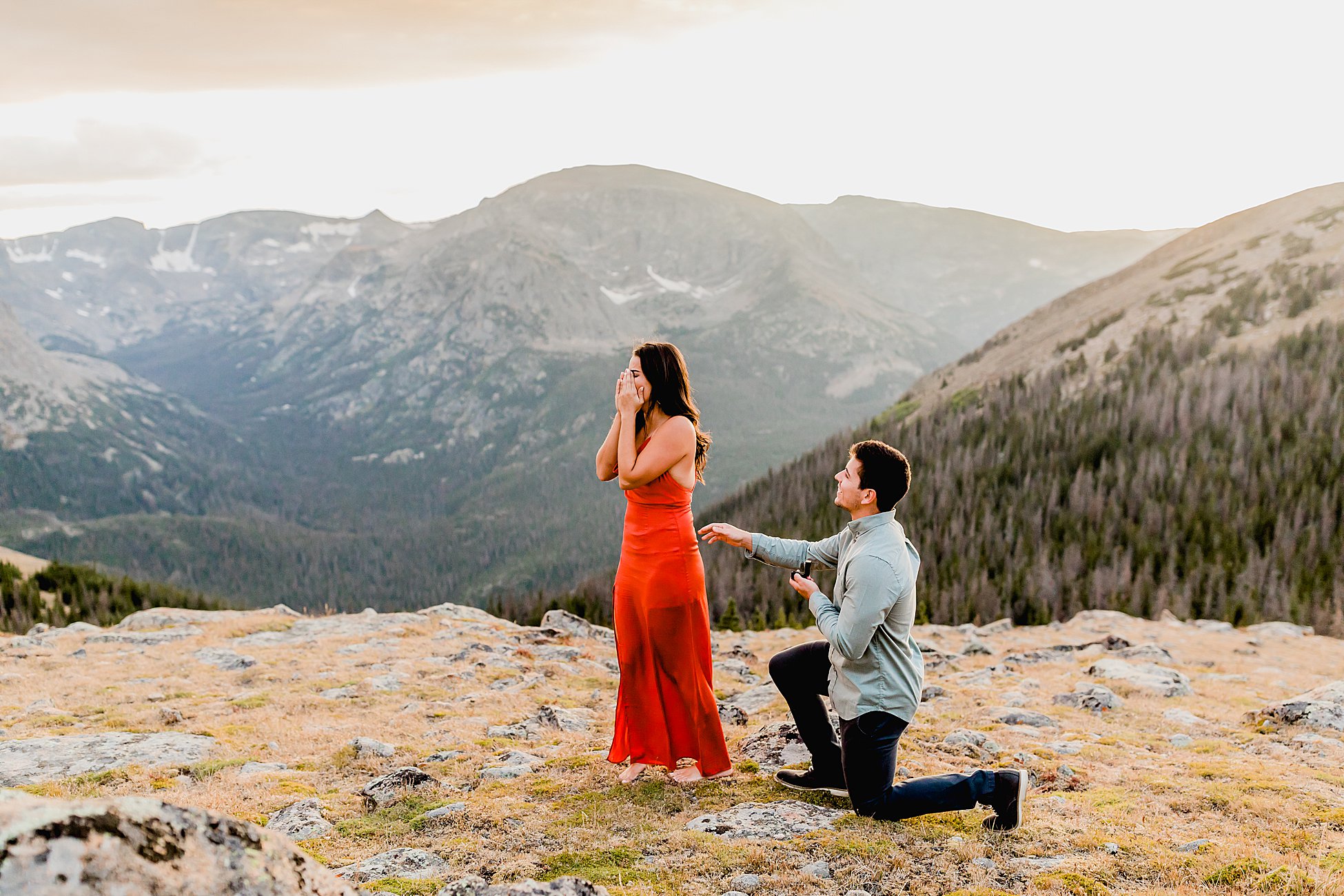 photographer captures rocky mountain national park proposal with gorgeous mountain scenery at sunset