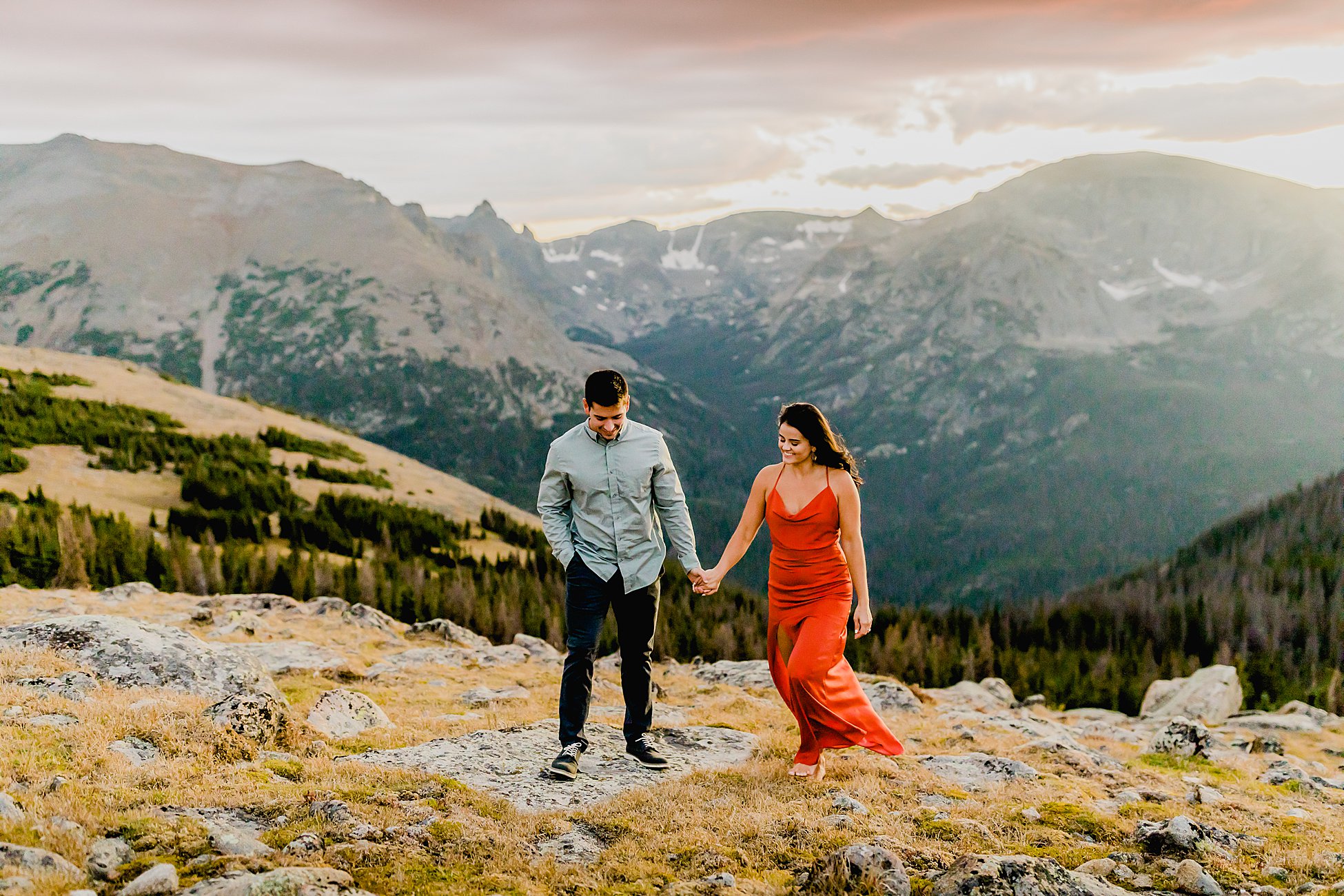 couple has rocky mountain national park adventure photos taken at sunset with stunning colorado landscape