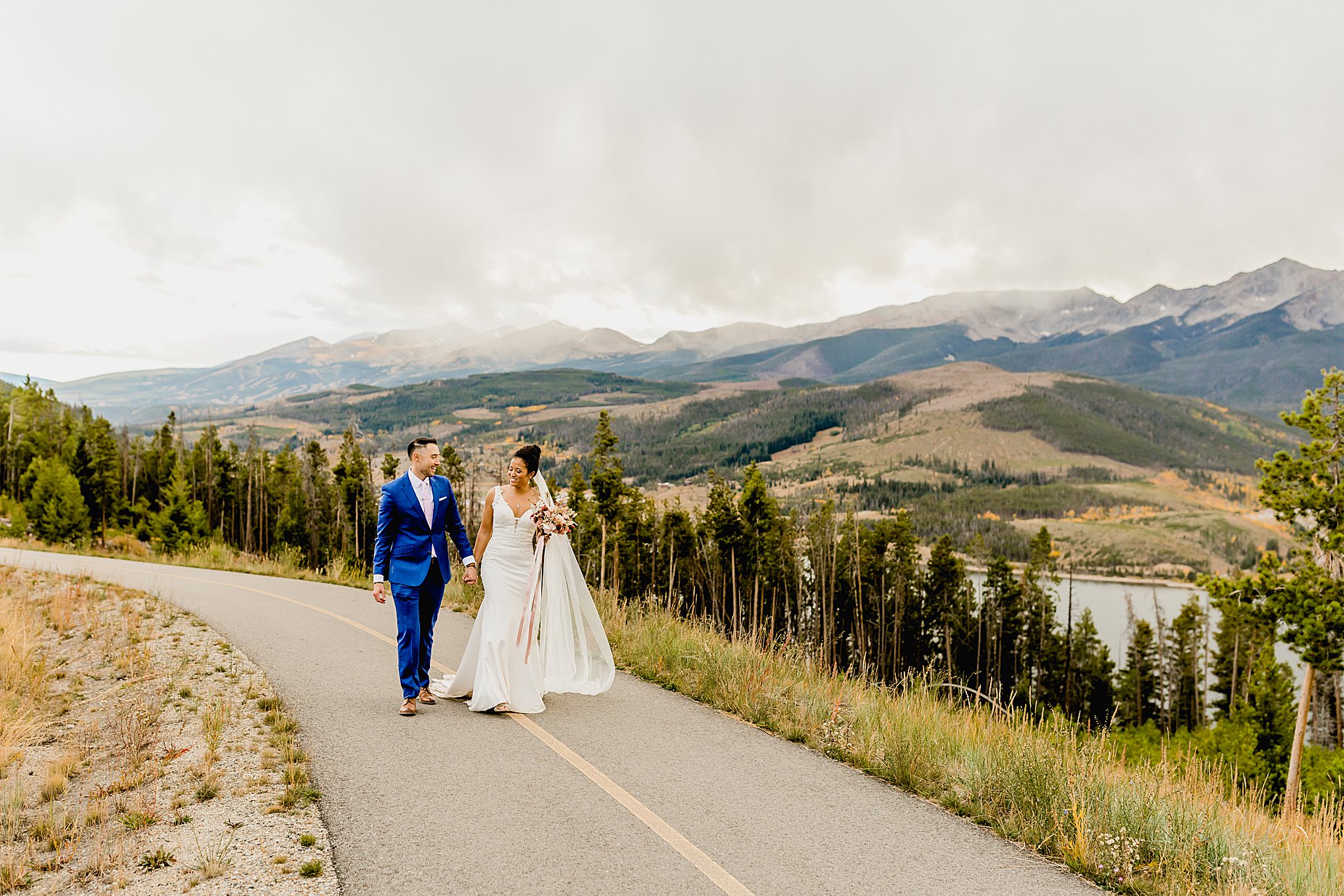 Bride and groom walk at Sapphire Point for their breckenridge fall elopement with stunning mountain and aspen views, captured by Lauren Casino Photography, a Colorado elopement photographer