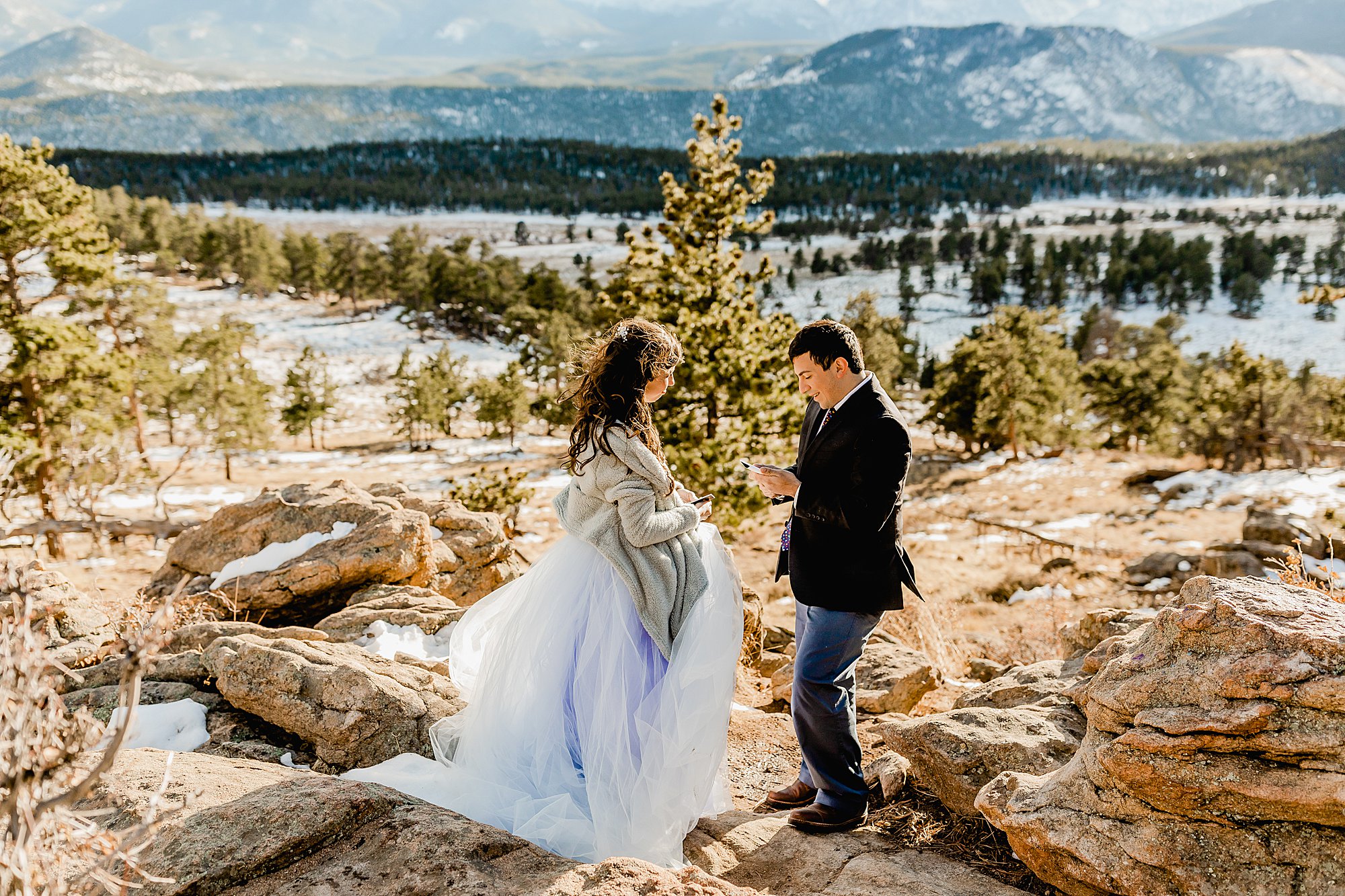 couple shares vows at 3m curve in rocky mountain national park with a beautiful mountain view in the background, photo by lauren casino photography