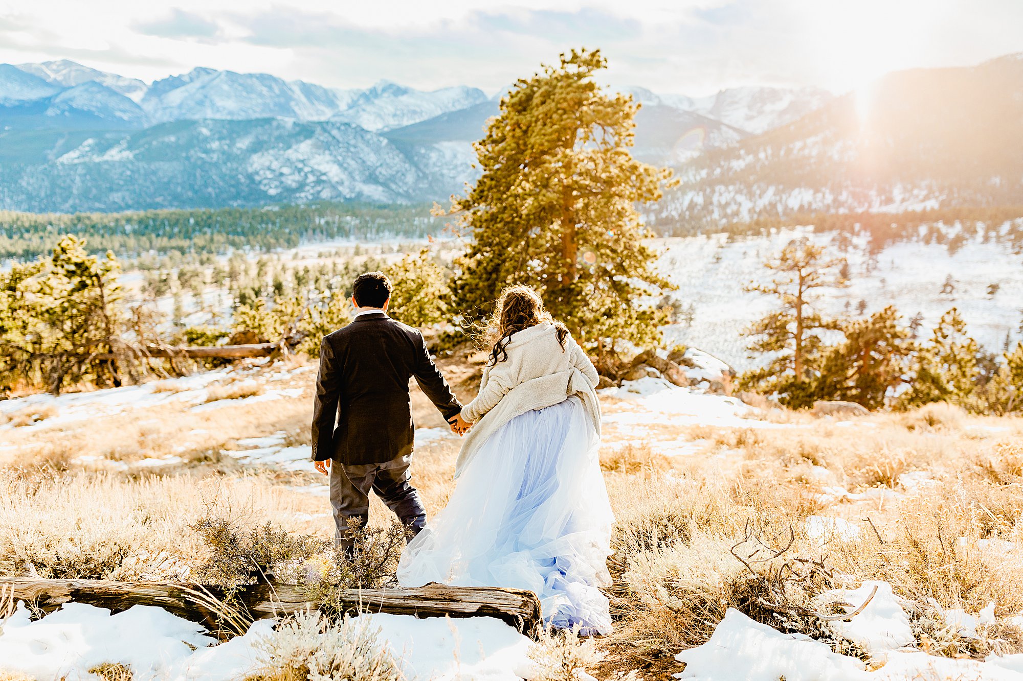 Couple explores rocky mountain national park for their winter elopement with gorgeous nature views surrounding them, photo by lauren casino photography