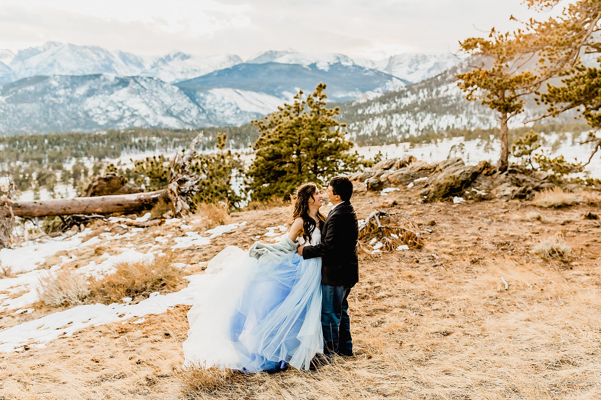Couple explores rocky mountain national park for their winter elopement with gorgeous nature views surrounding them, photo by lauren casino photography