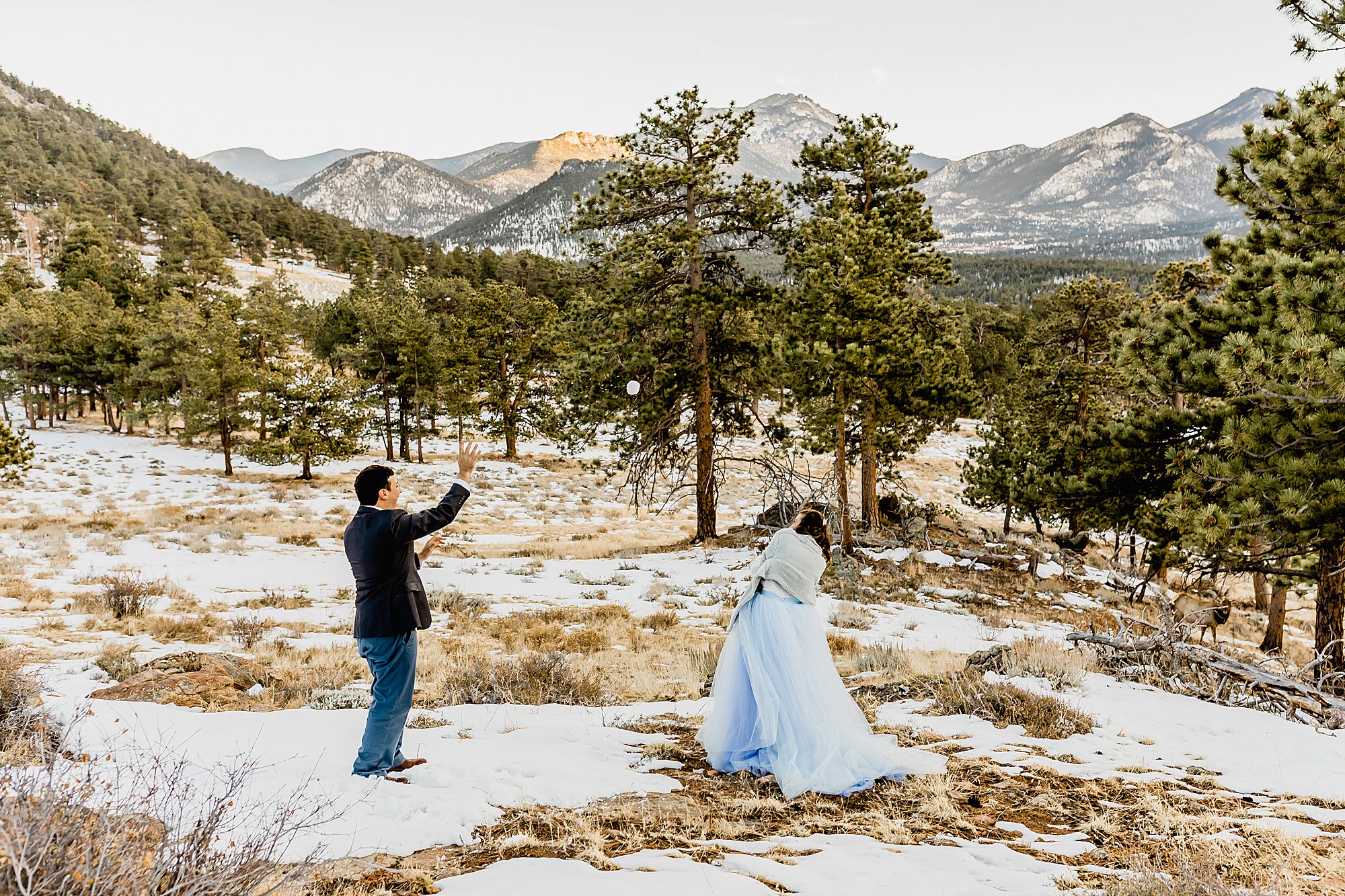 Couple has snowball fight in rocky mountain national park for their winter elopement