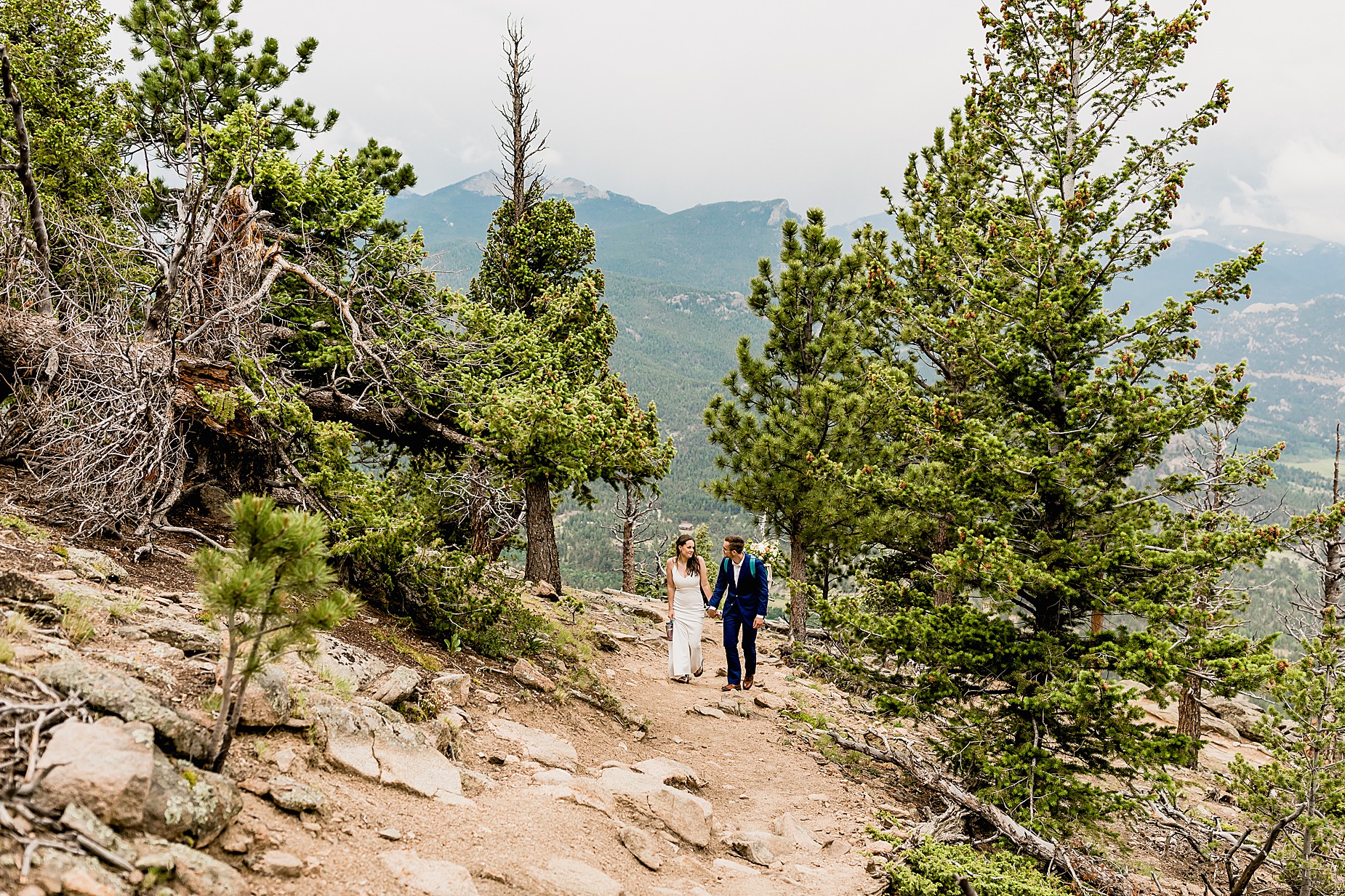 Bride and groom walk through the aspens for their Estes Park hiking elopement