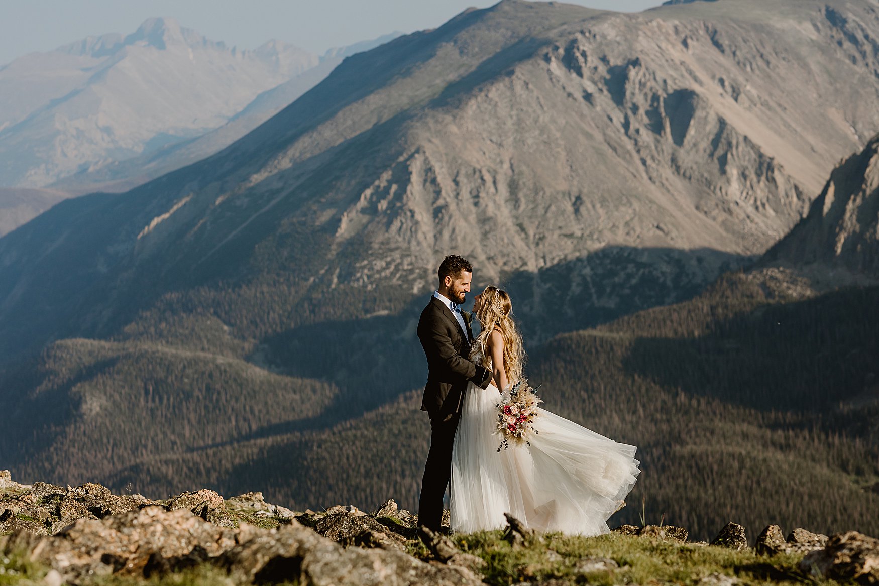 Bride and groom explore Rocky Mountain National park after their elopement ceremony on a summer day, photo by Lauren Casino Photography